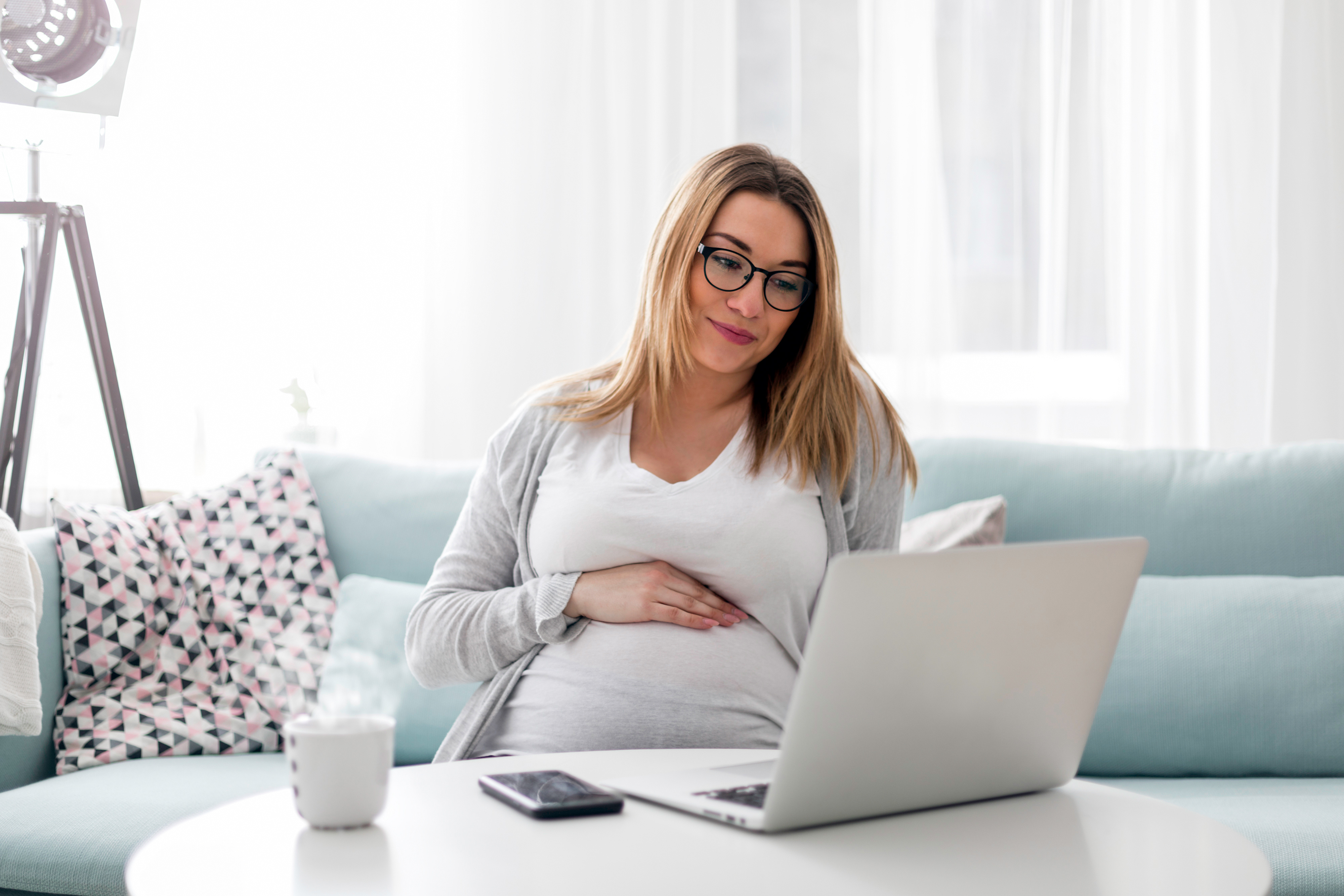 Pregnant woman viewing information on a laptop